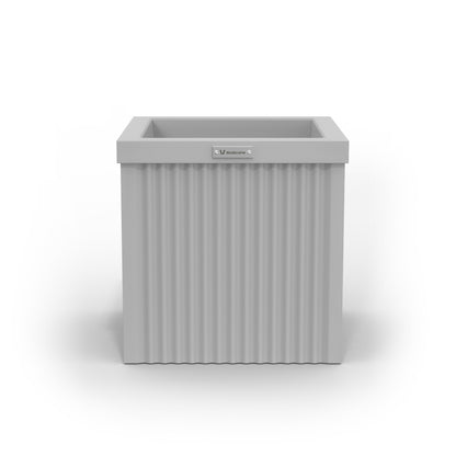 A small cube shaped planter pot in a light grey colour made by Modscene.